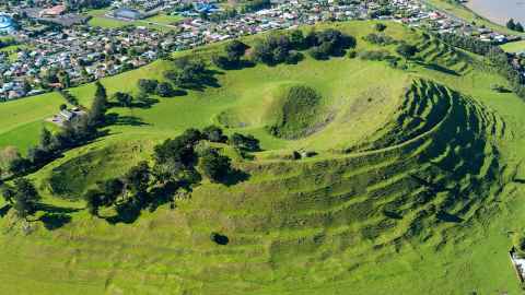 An aerial image of a grass covered New Zealand volcano